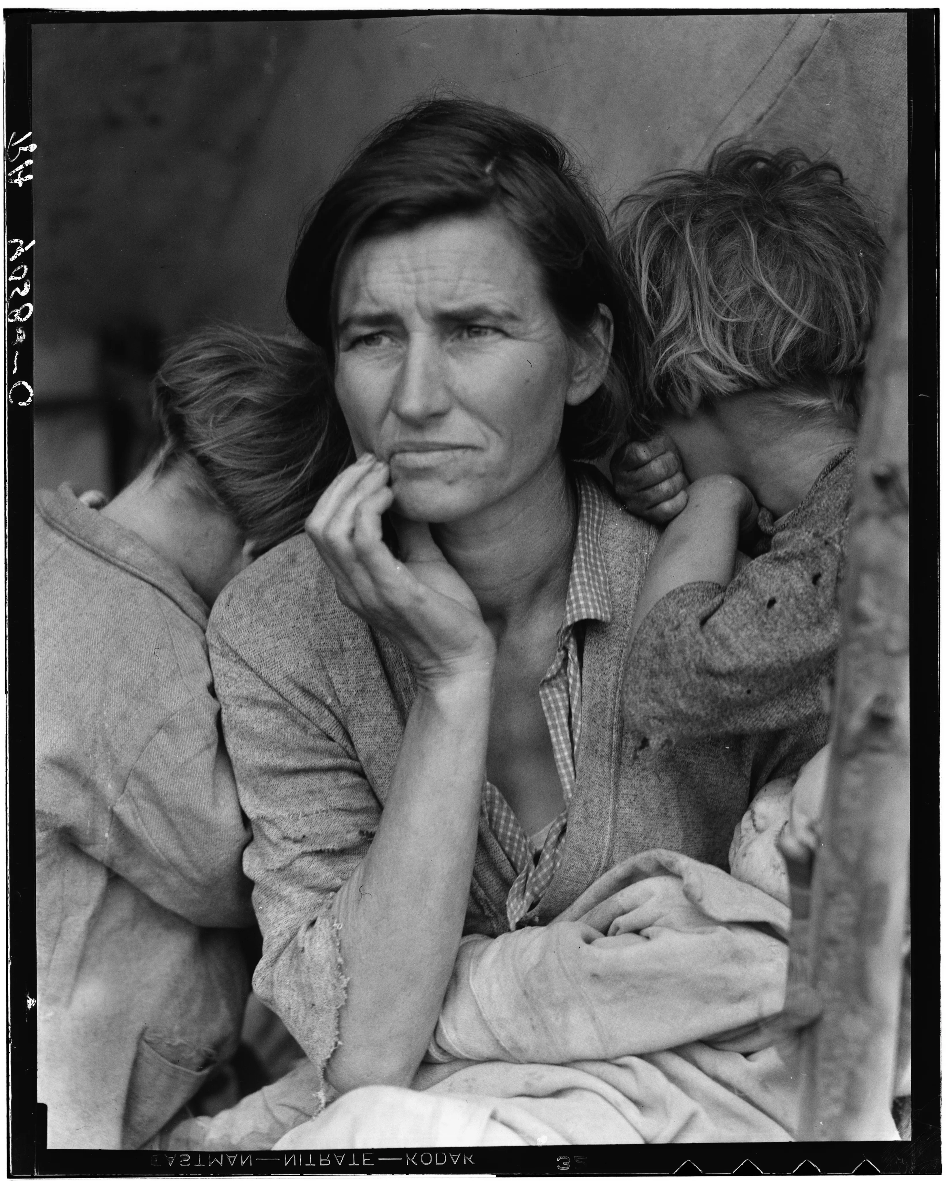 A mother at the center with children close beside her, two turning their faces inward.